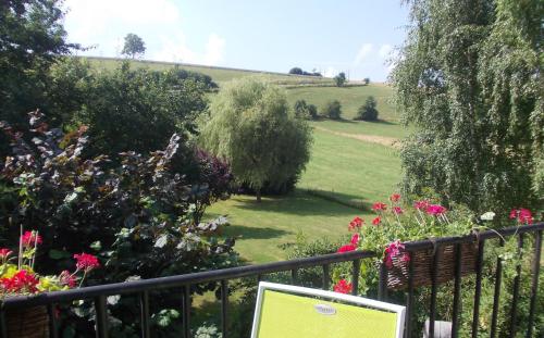 a view of a garden from a fence with flowers at Gite Saboti in Dinant