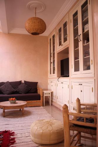 a living room with a couch and a table at Tifawin Apartment in Mirleft