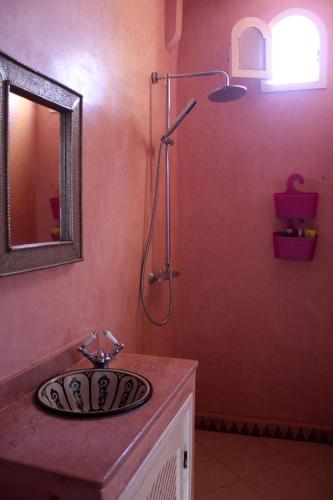 a bathroom with a sink and a shower at Tifawin Apartment in Mirleft
