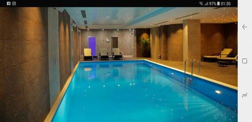 a large blue swimming pool in a hotel room at Apartment 408 in Orbi Palace in Bakuriani