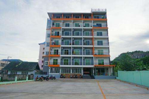 a tall building with motorcycles parked in front of it at A.D. Living in Hua Hin