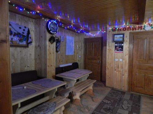 a room with a table and a bench and lights at Садиба Достаток in Kolomyya