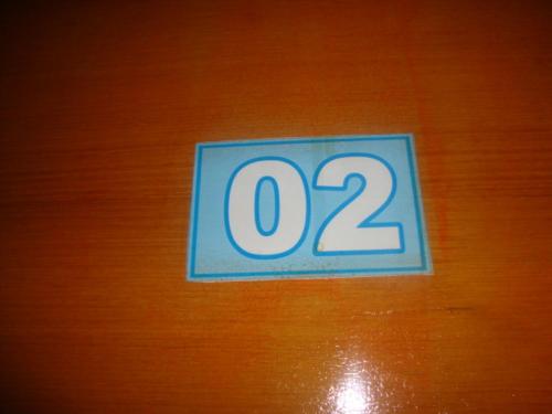 a sign with the number on a wooden table at Pousada III Poderes in Trindade