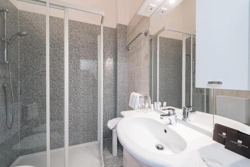 a bathroom with a sink and a shower at Villa Belvedere Como Lake Relais in Argegno