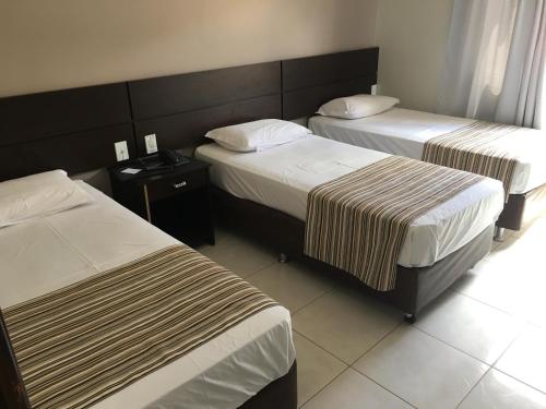 Postel nebo postele na pokoji v ubytování Hotel Notre Dame