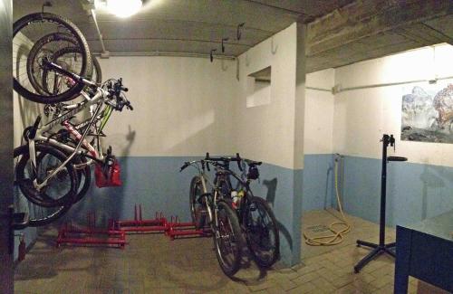 two bikes hanging on a wall in a garage at La Collina degli Ulivi in Vercana