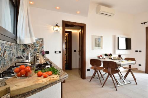 a kitchen with a counter with fruits and vegetables on it at Residence L'Ea di Lavru - Appartamenti Mono-Bilo-Trilocali in Porto San Paolo
