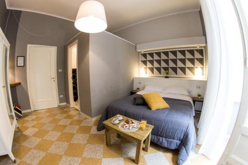 a bedroom with a bed and a desk at Balate Maqueda B&B in Palermo
