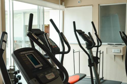 a gym with several cardio machines in a room at Hotel Sunset Beach in Punta del Este