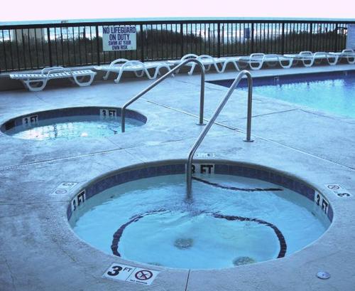 a swimming pool with a jacuzzi tub in the ground at Club Regency at Regency Towers in Myrtle Beach