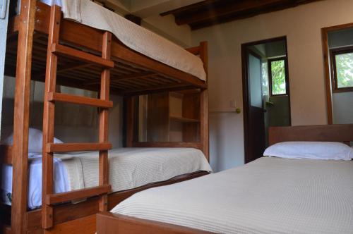 a bunk bed room with two bunk beds in it at La Facha Hostal Restaurant Surf in Mompiche
