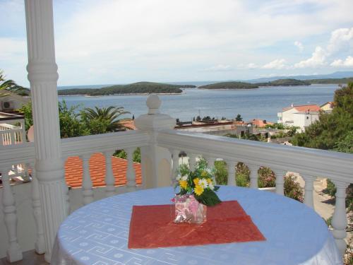 a table on a balcony with a view of the water at Apartmens Špiko 2 in Hvar