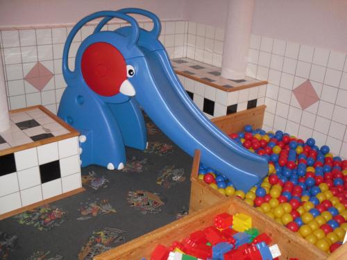 a childs play room with a slide and balls at Hotel Naggler Weissbriach in Weissbriach