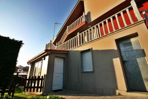 a house with a staircase on the side of it at Piso Don Ramón in Razo
