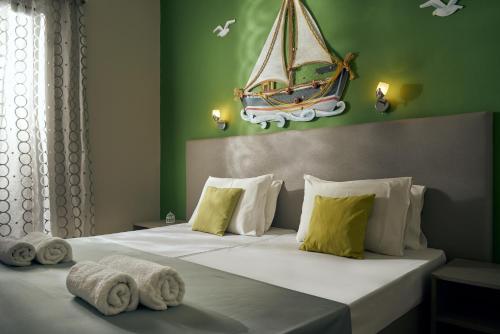 a bedroom with a bed with a boat on the wall at Elena's Studios in Kalamaki