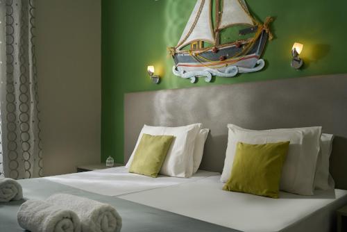 a bedroom with a bed with a boat above it at Elena's Studios in Kalamaki