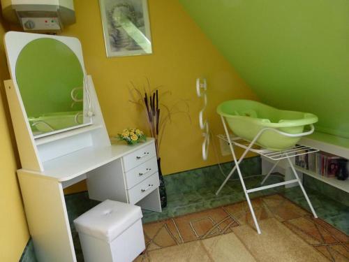 a bathroom with a sink and a mirror and a desk at Noclegi Barbara in Czorsztyn