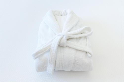 a white towel hanging on a white wall at Hotel Spa Calagrande Cabo de Gata in Las Negras