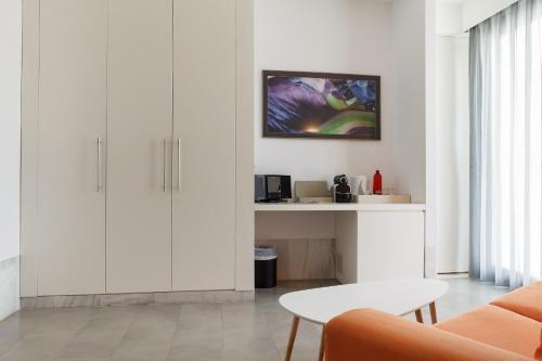 a living room with white cabinets and a table at Hotel Spa Calagrande Cabo de Gata in Las Negras