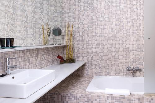 a bathroom with a white sink and a mirror at Hotel Spa Calagrande Cabo de Gata in Las Negras
