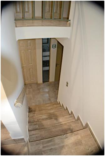 a staircase in a house with wooden floors at Hotel Herencia in Chillán