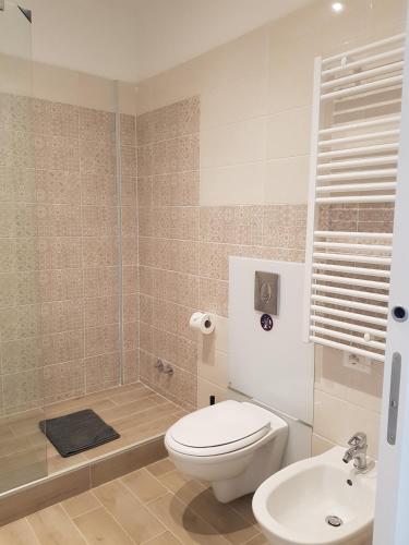 a bathroom with a toilet and a sink at Bsuites Scrovegni in Padova
