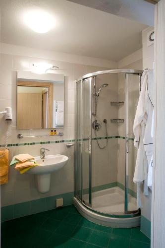 a bathroom with a shower and a sink at Miramare Resort in Tirrenia