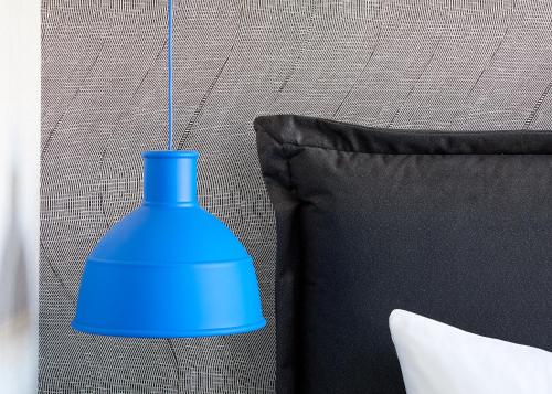 a blue vase sitting on a couch next to a pillow at Hutton Hotel in Nashville