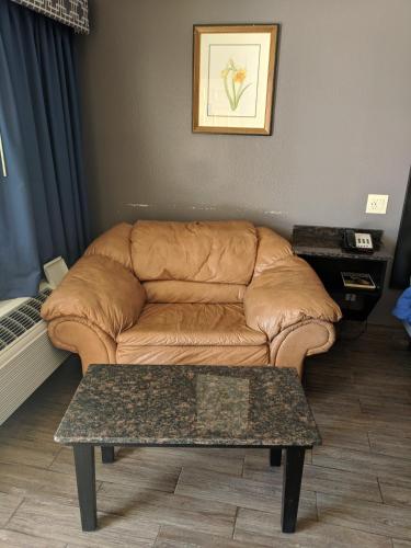 a living room with a couch and a coffee table at Americas Best Value Inn - Brownsville in Brownsville