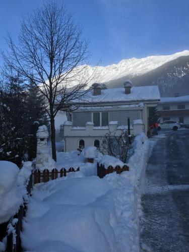 a house covered in snow with a fence at AlpinDesign Kaunertal in Kaunertal