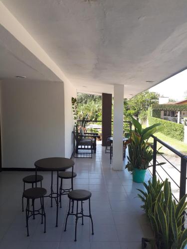 a patio with tables and chairs and plants at Hotel D Marco Exxpres in Palenque