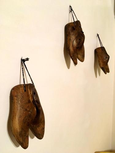 three pieces of animal heads hanging on a wall at Casa do Rio - Eido do Pomar in Arcos de Valdevez