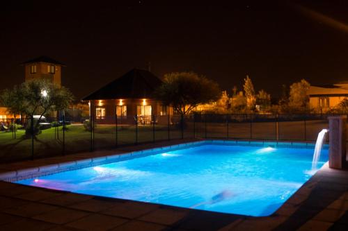 a swimming pool lit up at night at Luna de Colon in Colón