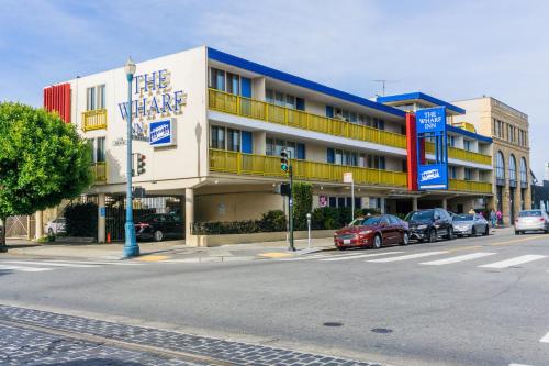 a building on a street with cars parked in front of it at The Wharf Inn in San Francisco