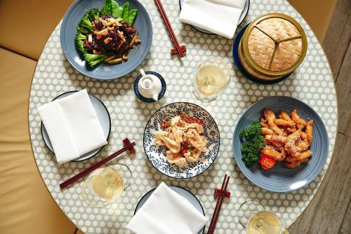 a table with three plates of food on it at The Ville Resort - Casino in Townsville
