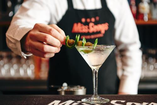 a bartender preparing a drink in a martini glass at The Ville Resort - Casino in Townsville