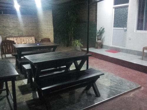 a room with tables and benches in a building at Araliya White House in Negombo