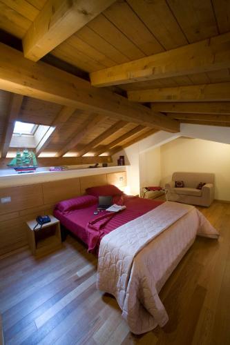 a bedroom with a large bed in a attic at Miramare Resort in Tirrenia