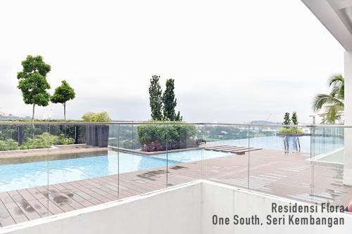 a view of a swimming pool from the balcony of a house at Residensi Flora in Seri Kembangan