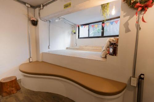 a train car with a bench in a room at May Rooms Taipei NTU in Taipei