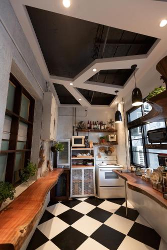 a kitchen with a black and white checkered floor at May Rooms Taipei NTU in Taipei