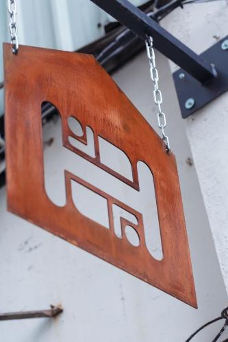 a wooden sign hanging from a chain at May Rooms Taipei NTU in Taipei