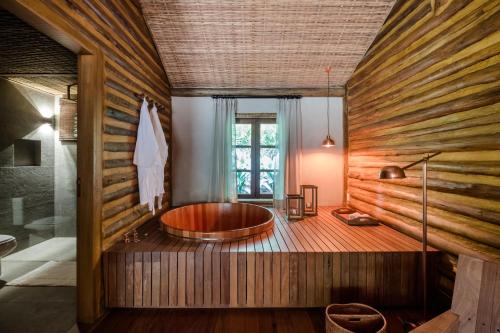 a bathroom with a tub in the middle of the room at Pousada Tankamana in Itaipava