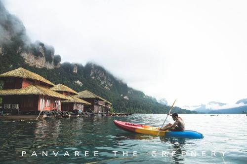 a man is in a kayak in the water at Panvaree The Greenery in Ban Chieo Ko