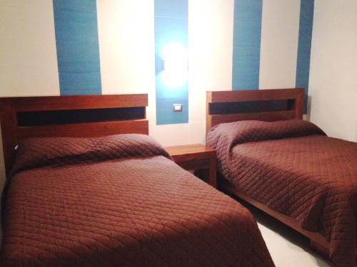 Ένα ή περισσότερα κρεβάτια σε δωμάτιο στο Hotel Claudia