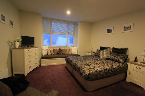 a bedroom with a bed and a window at Thredbo 31 in Thredbo
