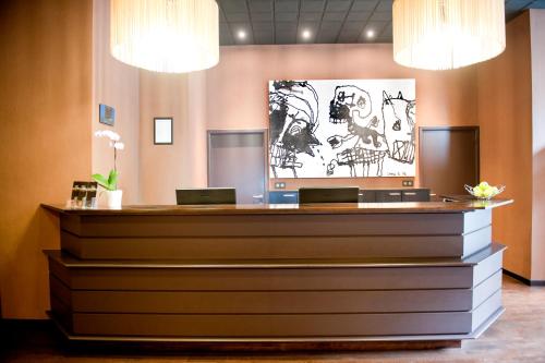 a reception desk in a lobby with two laptops at New Hotel Charlemagne in Brussels
