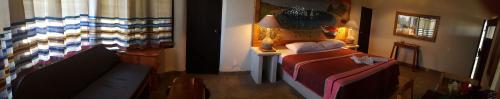 a bedroom with a bed and a lamp in a room at Casa Ofelia in Mazunte