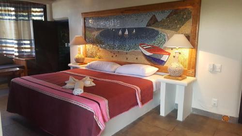 a bedroom with a bed with a stuffed animal on it at Casa Ofelia in Mazunte