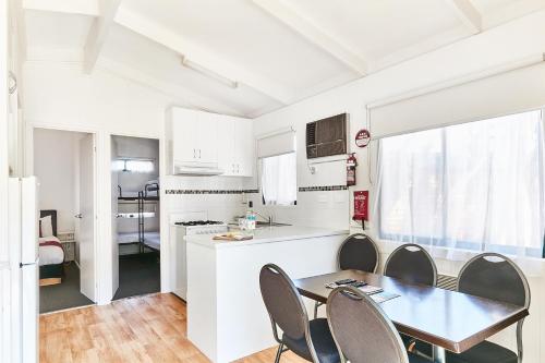 a kitchen and dining room with a table and chairs at Anglesea Family Caravan Park in Anglesea